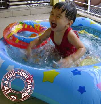 Ben playing in his water pool