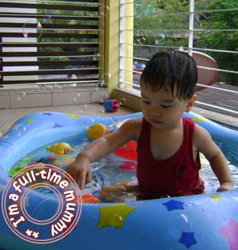 Ben playing in his water pool